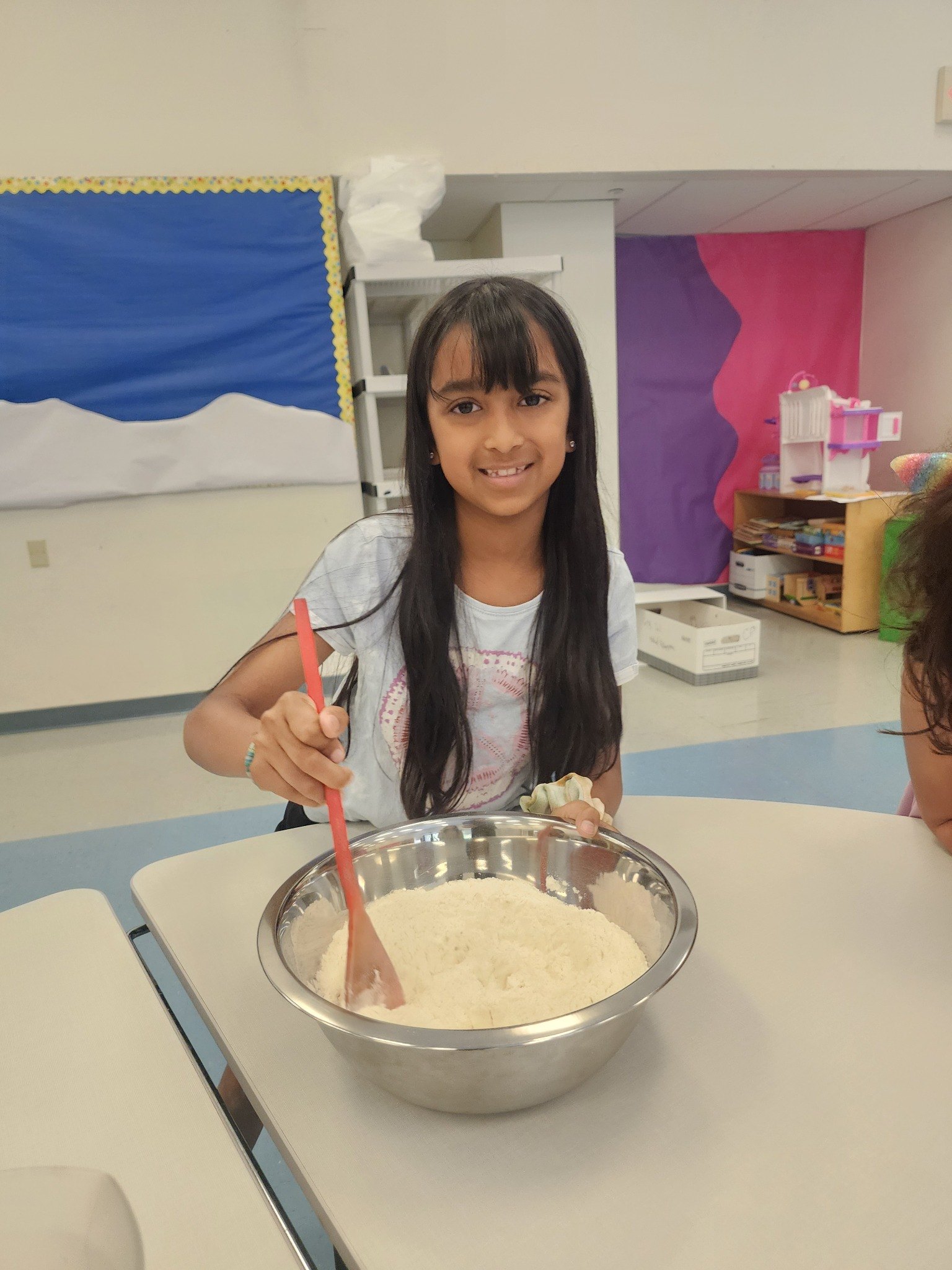 An older camper participating in a cooking activity